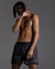 Black swimming trunks with script embroidery