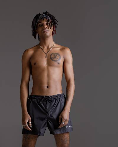 Black swimming trunks with script embroidery