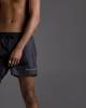 Black swimming trunks with script embroidery