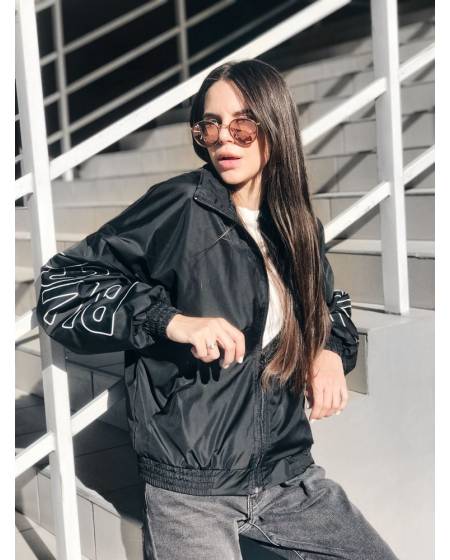 Women's windbreaker with black print on sleeves