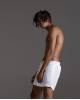 White swimming trunks with script embroidery